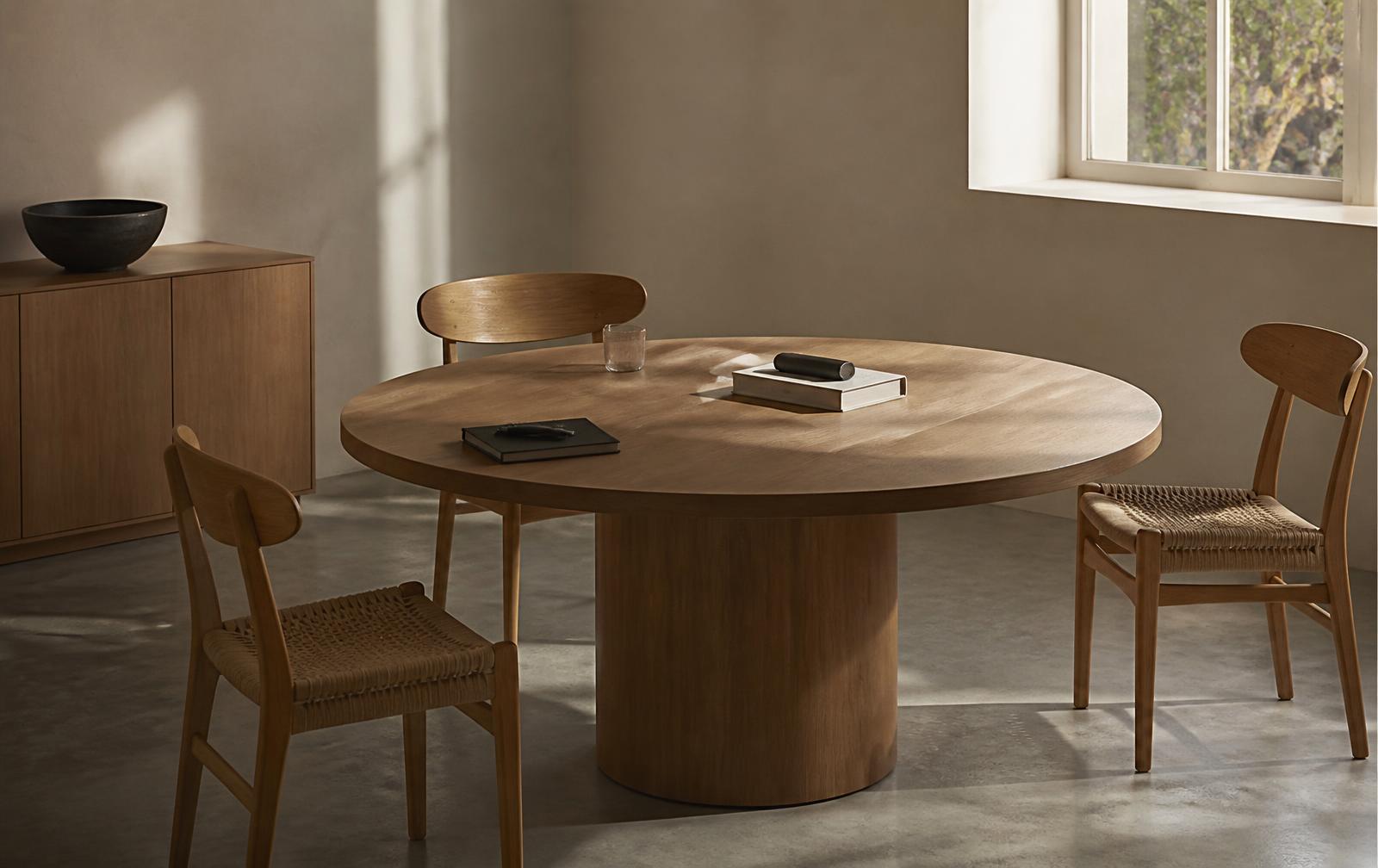An empty round oak table in quiet daylight